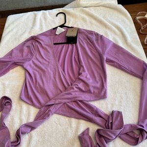 Ladies, Jordan, wrap workout top. Brand new w/tags. Size M. Excellent condition.